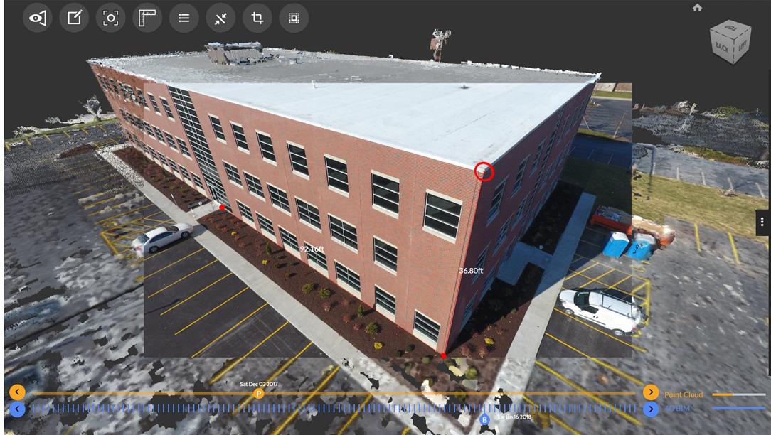 3D point cloud of a brick building exterior with on-screen measurement annotations for facade dimensions