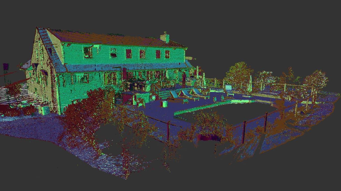Colored LiDAR point cloud of a building exterior showing dense surface coverage from multiple scan positions
