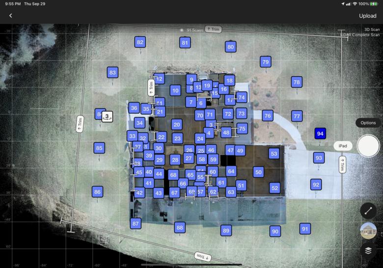 Tablet showing numbered LiDAR scan positions distributed across a building footprint for coverage planning